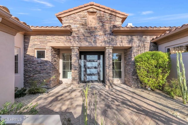 view of exterior entry featuring a patio