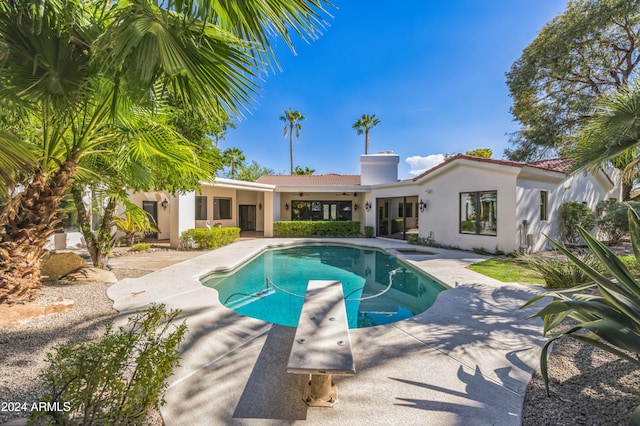 view of pool featuring a diving board and a patio area