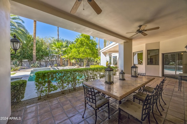 view of patio / terrace featuring a fenced in pool and ceiling fan