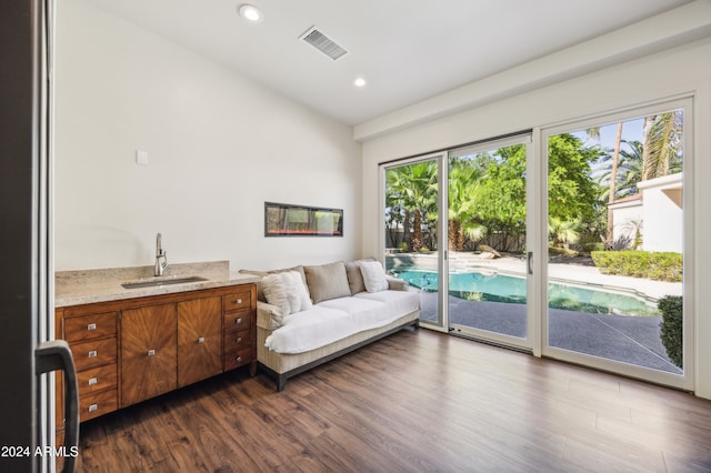 sitting room with dark hardwood / wood-style flooring and sink