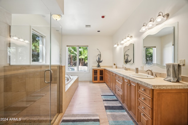 bathroom with vanity, hardwood / wood-style flooring, and separate shower and tub