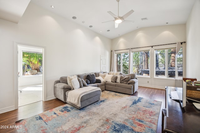 living room with ceiling fan, dark hardwood / wood-style flooring, and high vaulted ceiling