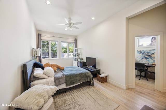 bedroom with light hardwood / wood-style flooring and ceiling fan