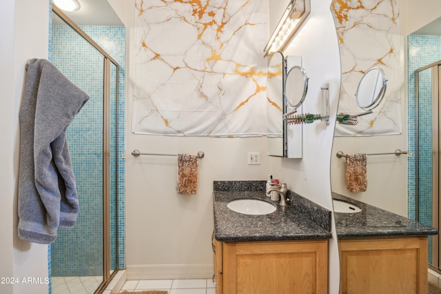 bathroom featuring tile patterned floors, vanity, and walk in shower