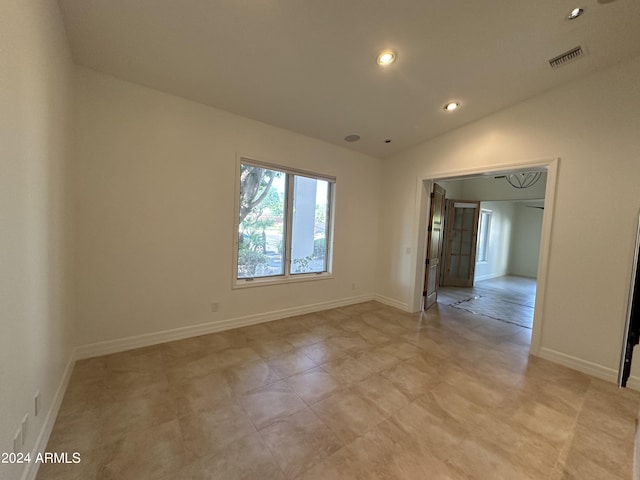 spare room with vaulted ceiling