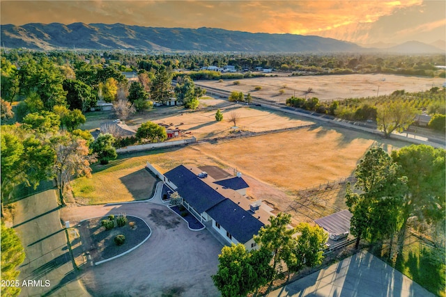 aerial view at dusk featuring a mountain view