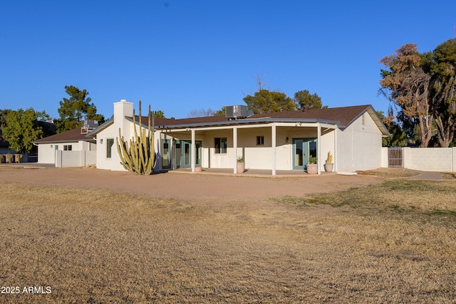 rear view of property with cooling unit