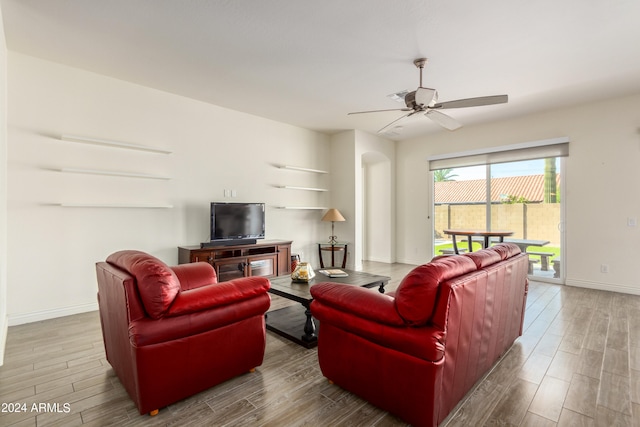 living room featuring wood-type flooring and ceiling fan