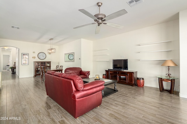 living room featuring light wood-type flooring and ceiling fan