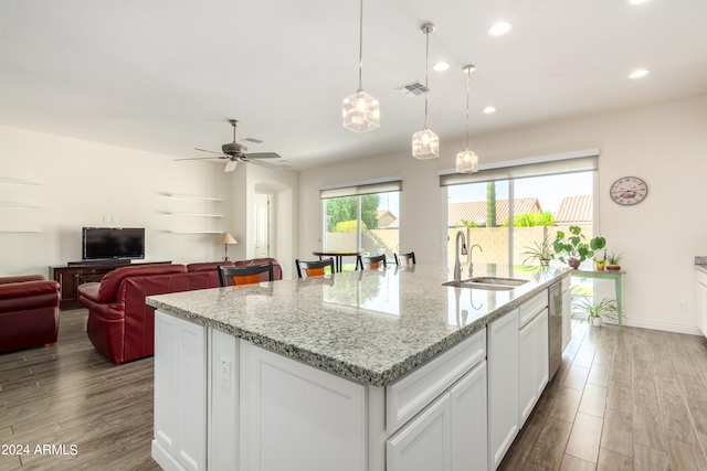 kitchen with ceiling fan, light stone countertops, white cabinets, and light hardwood / wood-style floors