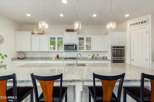 kitchen with a large island, stainless steel appliances, and sink