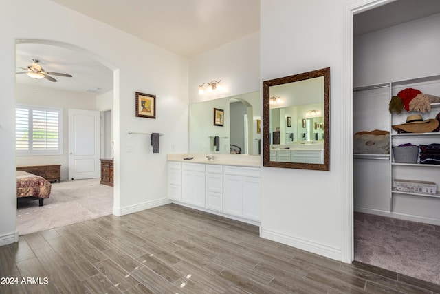 bathroom featuring vanity, wood-type flooring, and ceiling fan