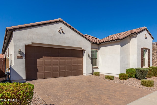 mediterranean / spanish house with a garage