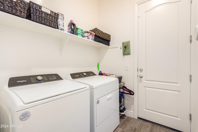 laundry area featuring separate washer and dryer and dark hardwood / wood-style floors