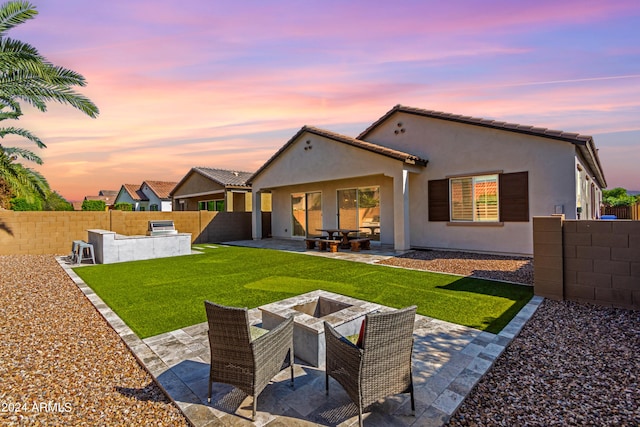 view of patio with area for grilling and a grill