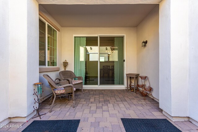 back of property featuring a lawn and a patio