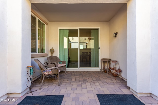 view of exterior entry featuring a patio