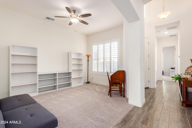 sitting room with wood-type flooring and ceiling fan