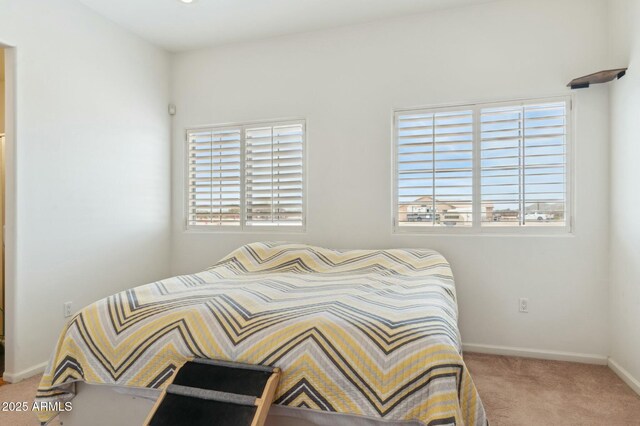bedroom with carpet flooring and baseboards