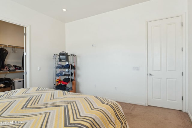 bedroom with light carpet, recessed lighting, a spacious closet, and a closet