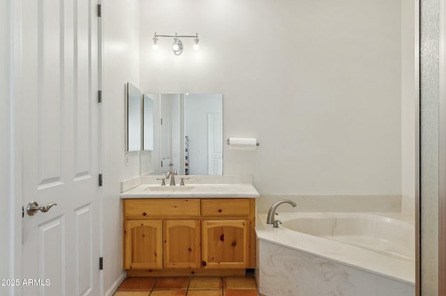 bathroom with tile patterned floors, vanity, and a garden tub