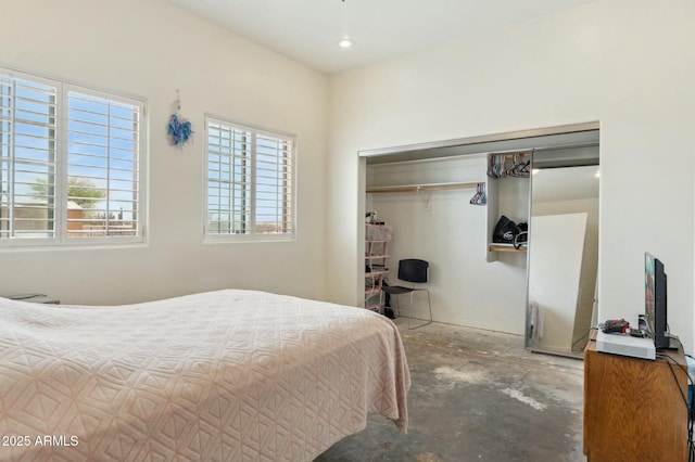 bedroom featuring a closet and concrete flooring