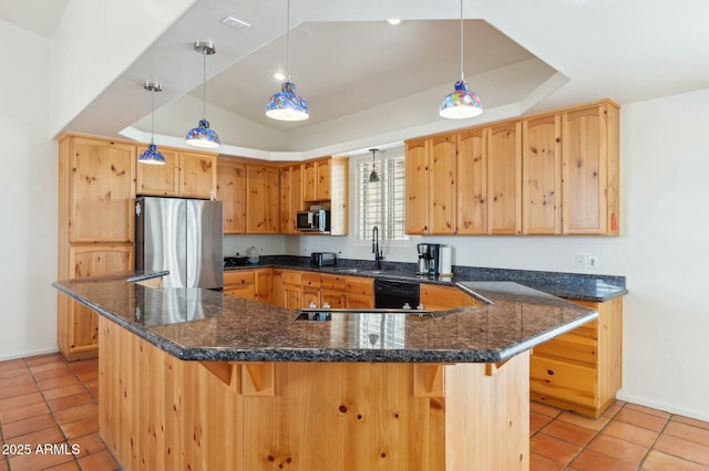 kitchen with baseboards, a tray ceiling, a sink, and appliances with stainless steel finishes