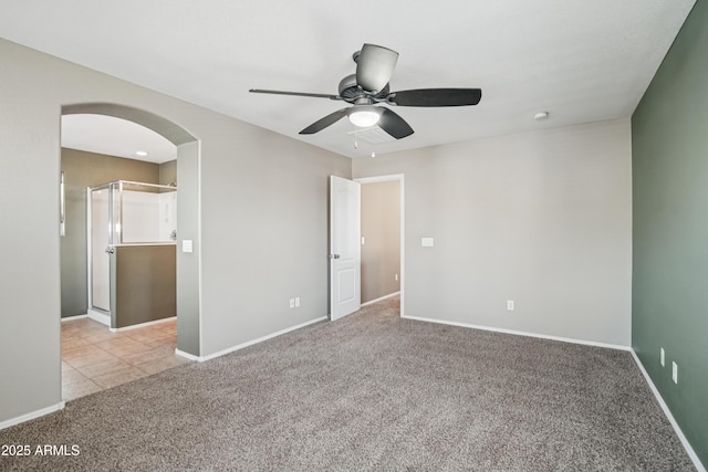 2947 N Evergreen St, Buckeye, AZ 85396 - unfurnished bedroom featuring arched walkways, carpet flooring, and ceiling fan