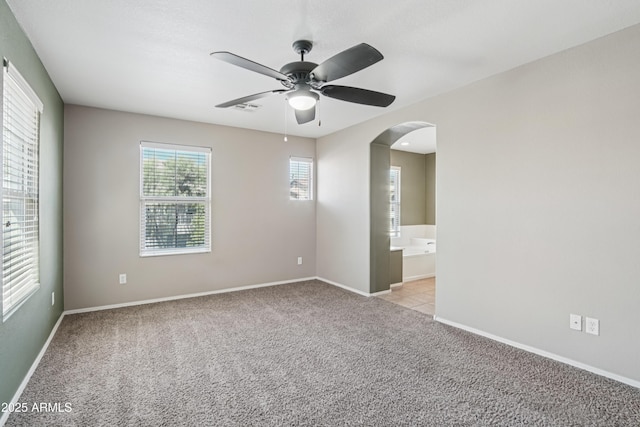 2947 N Evergreen St, Buckeye, AZ 85396 - unfurnished room with arched walkways, ceiling fan, and carpet