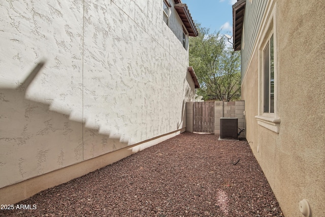 2947 N Evergreen St, Buckeye, AZ 85396 - view of home's exterior with stucco siding and a central AC unit