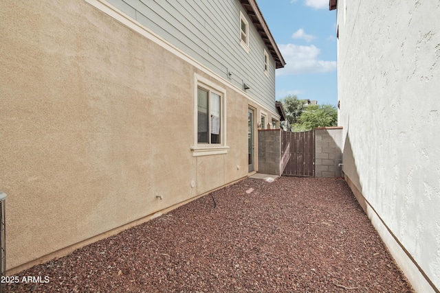 2947 N Evergreen St, Buckeye, AZ 85396 - view of home's exterior with stucco siding and a gate