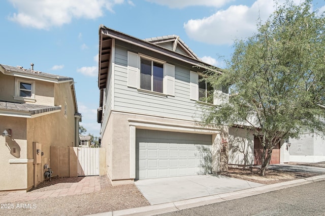 2947 N Evergreen St, Buckeye, AZ 85396 - view of front of house featuring driveway, a garage, and stucco siding