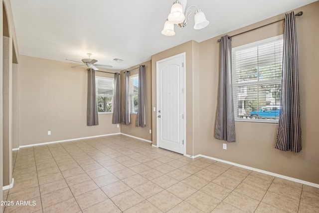 2947 N Evergreen St, Buckeye, AZ 85396 - spare room featuring a chandelier, light tile patterned flooring, healthy amount of natural light, and ceiling fan