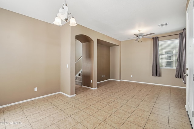 2947 N Evergreen St, Buckeye, AZ 85396 - empty room with light tile patterned floors, stairs, a chandelier, and a ceiling fan