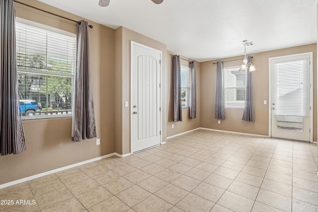 2947 N Evergreen St, Buckeye, AZ 85396 - entryway with light tile patterned floors, plenty of natural light, and a ceiling fan