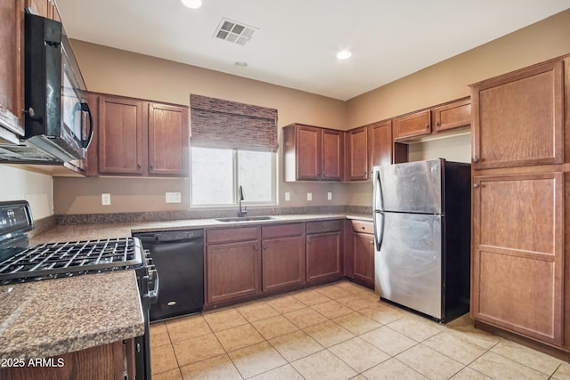 2947 N Evergreen St, Buckeye, AZ 85396 - kitchen featuring black appliances, light tile patterned floors, and recessed lighting