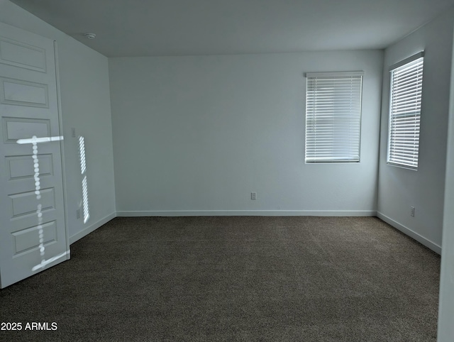 4330 N 94th Ave, Phoenix, AZ 85037 - empty room with dark colored carpet and baseboards