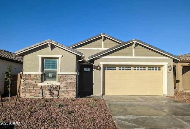 4330 N 94th Ave, Phoenix, AZ 85037 - view of front of home with stucco siding, stone siding, a garage, and driveway