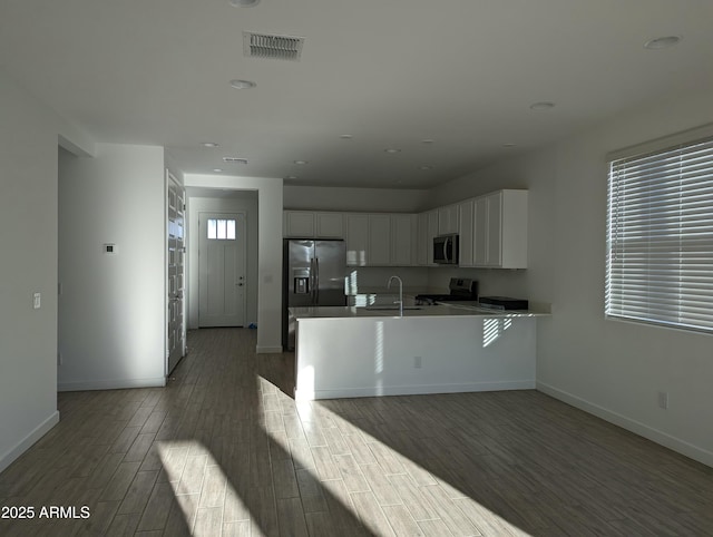 4330 N 94th Ave, Phoenix, AZ 85037 - kitchen with visible vents, baseboards, appliances with stainless steel finishes, wood finished floors, and white cabinetry