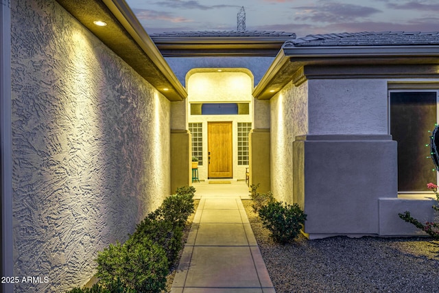 8132 W Hatfield Rd, Peoria, AZ 85383 - exterior entry at dusk featuring stucco siding