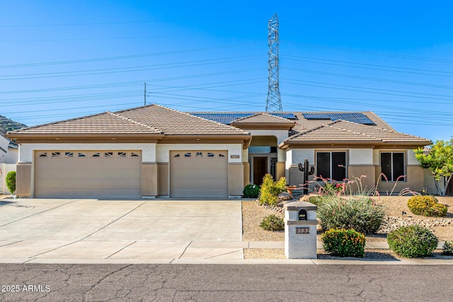 8132 W Hatfield Rd, Peoria, AZ 85383 - view of front of home with stucco siding, concrete driveway, an attached garage, and roof mounted solar panels