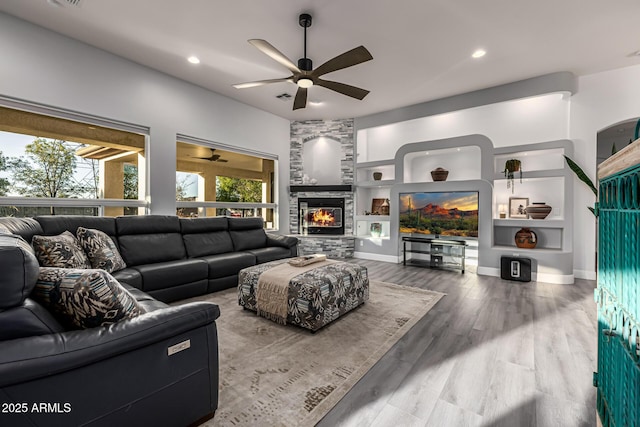 8132 W Hatfield Rd, Peoria, AZ 85383 - living area with ceiling fan, wood finished floors, built in features, a fireplace, and recessed lighting