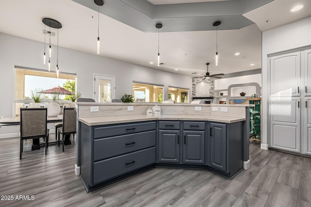 8132 W Hatfield Rd, Peoria, AZ 85383 - kitchen featuring ceiling fan, decorative light fixtures, light wood-style flooring, recessed lighting, and a kitchen island