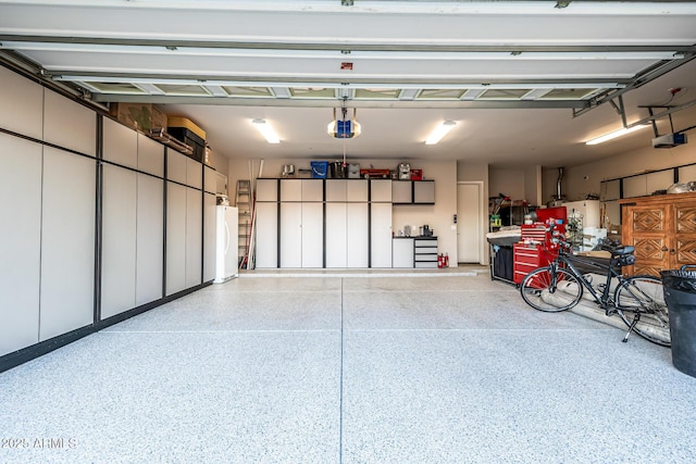 8132 W Hatfield Rd, Peoria, AZ 85383 - garage with a garage door opener and freestanding refrigerator
