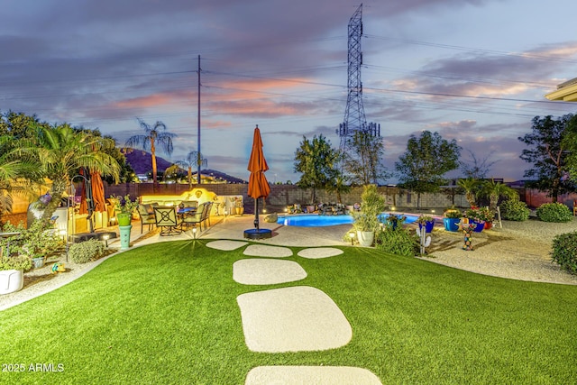 8132 W Hatfield Rd, Peoria, AZ 85383 - yard at dusk with a patio and a fenced backyard