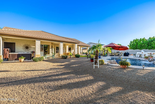 8132 W Hatfield Rd, Peoria, AZ 85383 - back of house featuring a hot tub, a patio area, and stucco siding