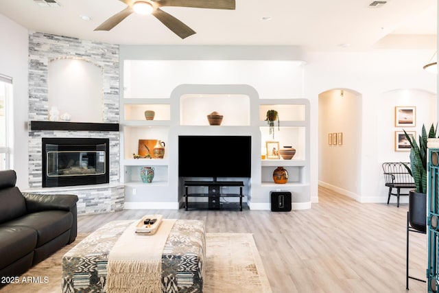 8132 W Hatfield Rd, Peoria, AZ 85383 - living room featuring a ceiling fan, built in features, wood finished floors, and a fireplace
