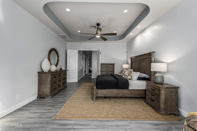 8132 W Hatfield Rd, Peoria, AZ 85383 - bedroom featuring recessed lighting, a raised ceiling, ceiling fan, and wood finished floors