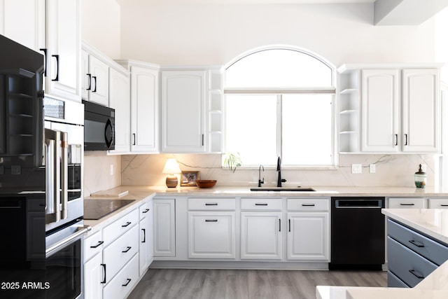 8132 W Hatfield Rd, Peoria, AZ 85383 - kitchen with black appliances, open shelves, white cabinetry, and decorative backsplash