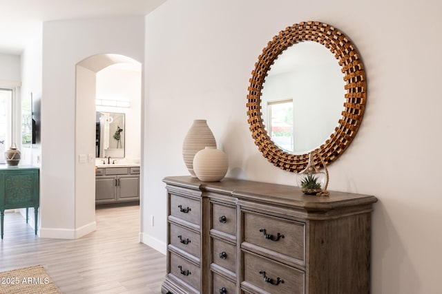 8132 W Hatfield Rd, Peoria, AZ 85383 - corridor featuring arched walkways, light wood-style floors, and plenty of natural light